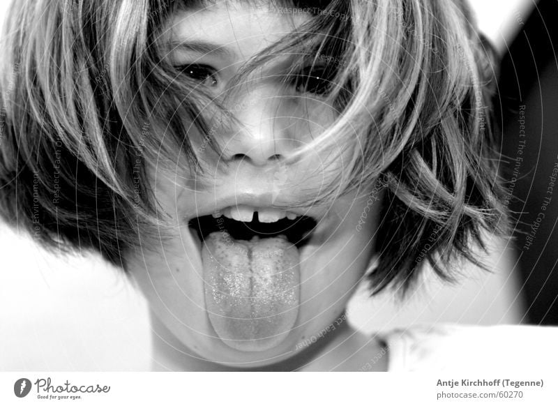 cheeky monkey Child Girl Disheveled Brash Tongue Funny Schoolchild Childlike Childish Infancy Portrait photograph Face of a child Black & white photo