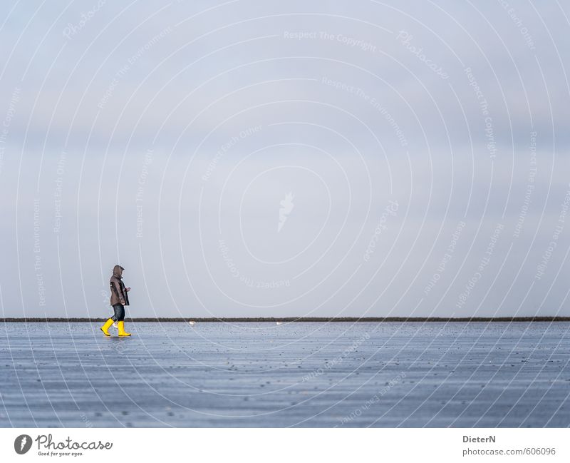 yellow 1 Human being Sand Water Sky Coast Beach Blue Yellow Gray Rubber boots Colour photo Copy Space left Copy Space right Copy Space top Copy Space bottom