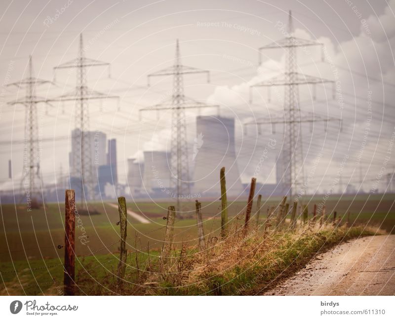 Lignite-fired power plant in NRW with power pylons and power lines in the foreground. Fields. Climate change Lignite power plant CO2 emission co2