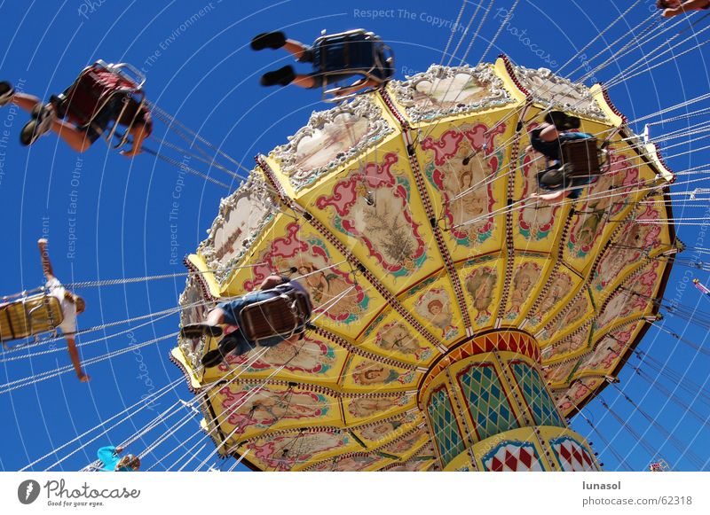 Twirly swing ride Blue sky easter show amusement park ride theme park hanging round and round fun childhood