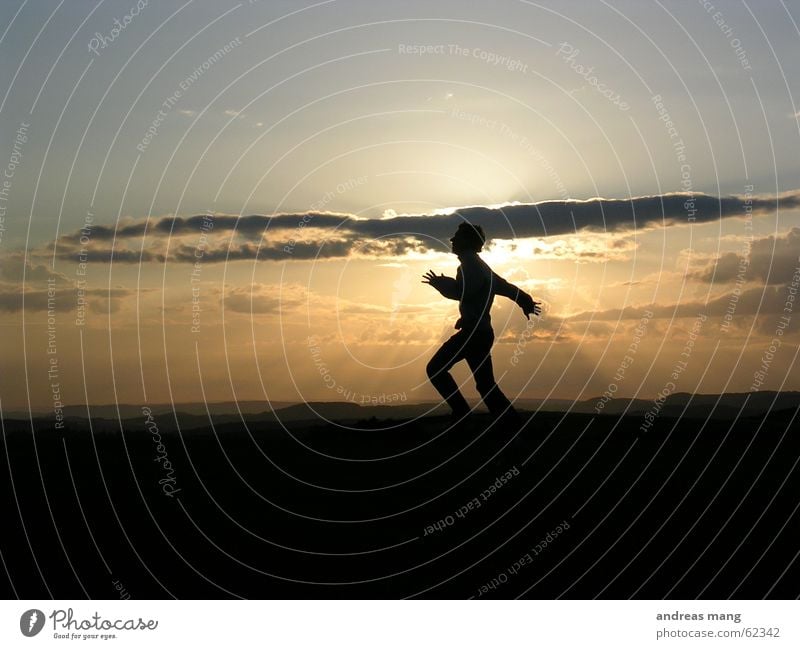 Reaching for the sun Jump Sunset Sky Horizon Clouds Man Hand Dusk Lighting Landscape Mountain mountains cloud Human being boy Joy fun enjoy freedom hands