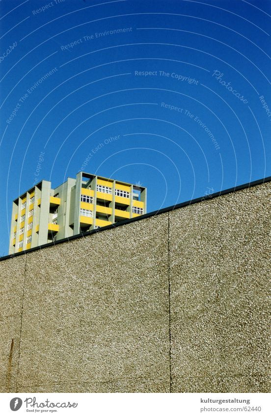 Berlin prefabricated building behind a wall Prefab construction East Wall (barrier) Town Concrete Yellow House (Residential Structure) High-rise Balcony