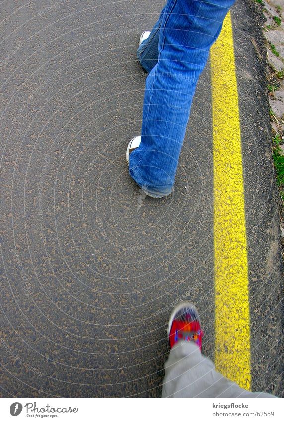 blue-red-yellow Legs Lanes & trails Pants Jeans Footwear Stripe Going Blue Yellow Red Chucks Edge Stride Sidewalk Colour photo Exterior shot Copy Space left