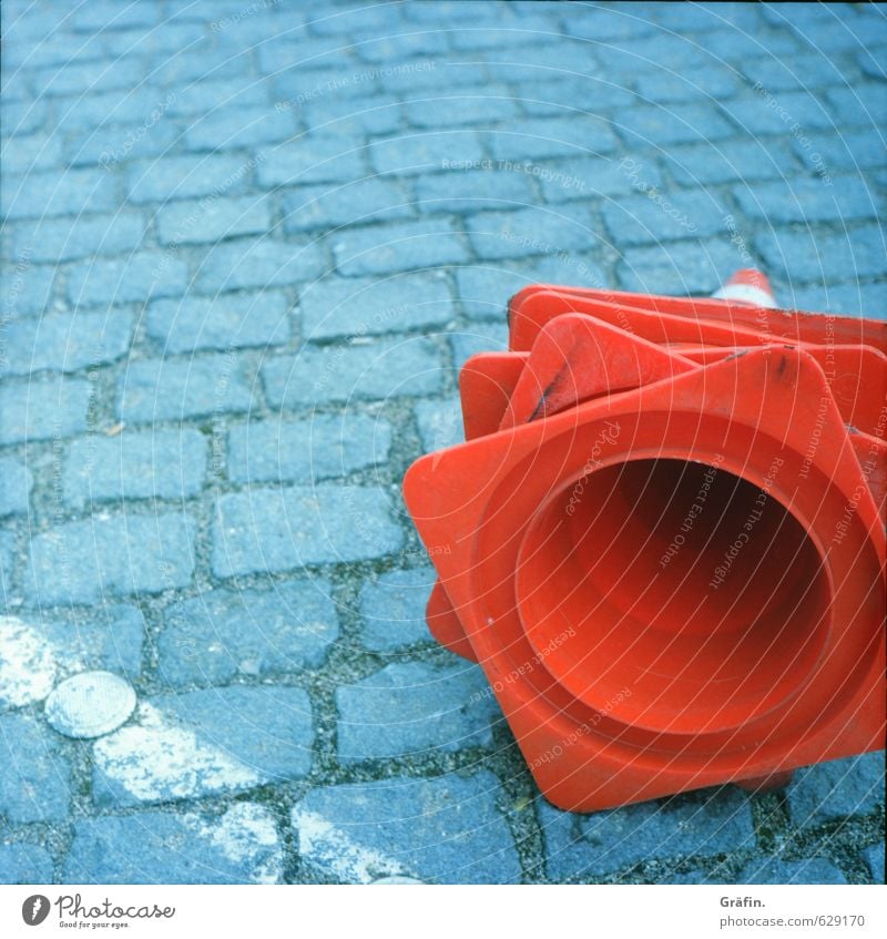 hat game Street Road sign Cobblestones Stone Lie Wait Town Gray Red Diligent Disciplined Date Logistics Construction site Barrier Colour photo Exterior shot