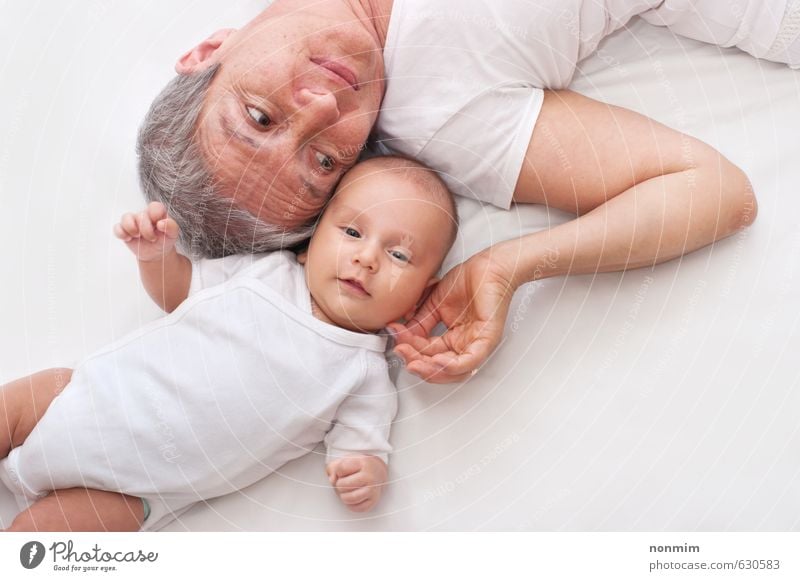 Grandmother and grandson lying on the ground, baby is looking at the camera Joy Face Child Human being Baby Toddler Boy (child) Woman Adults Female senior