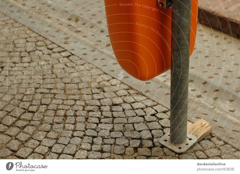 street furniture Gray Trash container Wastepaper basket Cobblestones Old Dirty Orange wooden wedge Pole