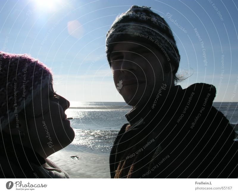 Julia and Jörg Ocean Beach Winter February St. Peter-Ording Cap Sunday Dazzle Back-light Wink Love Light Water Couple sea shadow Lovers Together Relationship