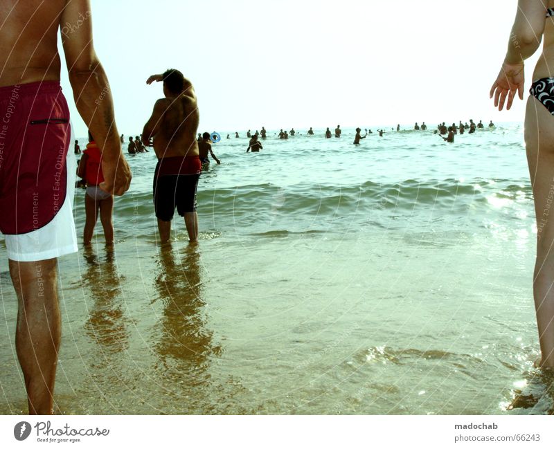 WAITING FOR THE FLOOD Ocean Human being Man Woman Horizon Beach Stand Looking Left Right Edge Hand Swimming trunks Summer Sun Far-off places Vacation & Travel