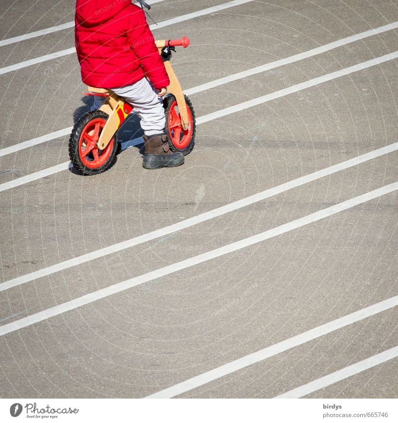 Toddler with a running wheel Playing impeller 1 Human being 3 - 8 years Child Infancy Line Wait Positive Gray Red White Cycling Serene Easygoing