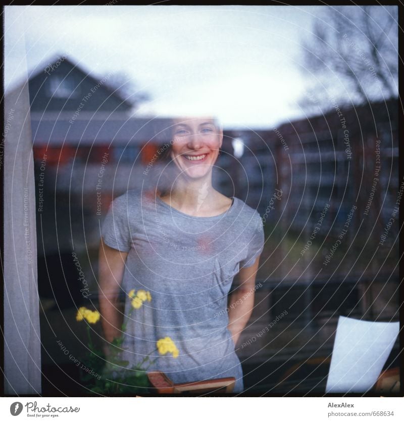 analogue portrait of a young, smiling woman behind a window pane Young woman Youth (Young adults) Head pit 18 - 30 years Adults Flower Apartment house