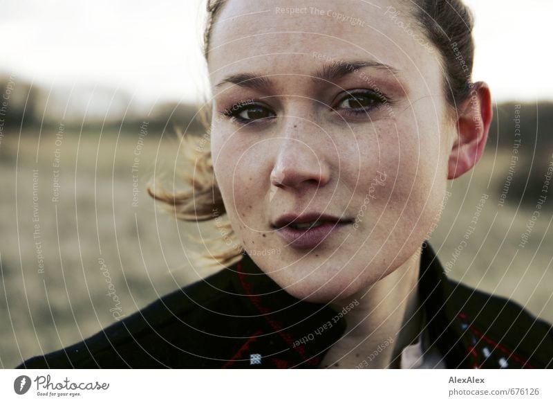 Exterior portrait of a young woman with wind Young woman Youth (Young adults) Face 18 - 30 years Adults Jacket brunette Long-haired Freckles Observe Communicate