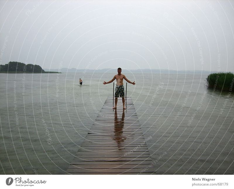 Give me Power Lake Footbridge Wet Reflection Cold Bad weather Gray Water Rain Human being Clouds