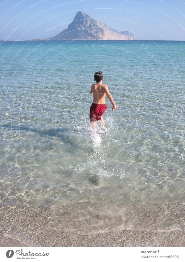 off to the south Azure blue Ocean South Italy Sardinia Beach Sandy beach Jump Horizon Lagoon Sunlight Physics Swimming trunks Sky Blue Island Boy (child)