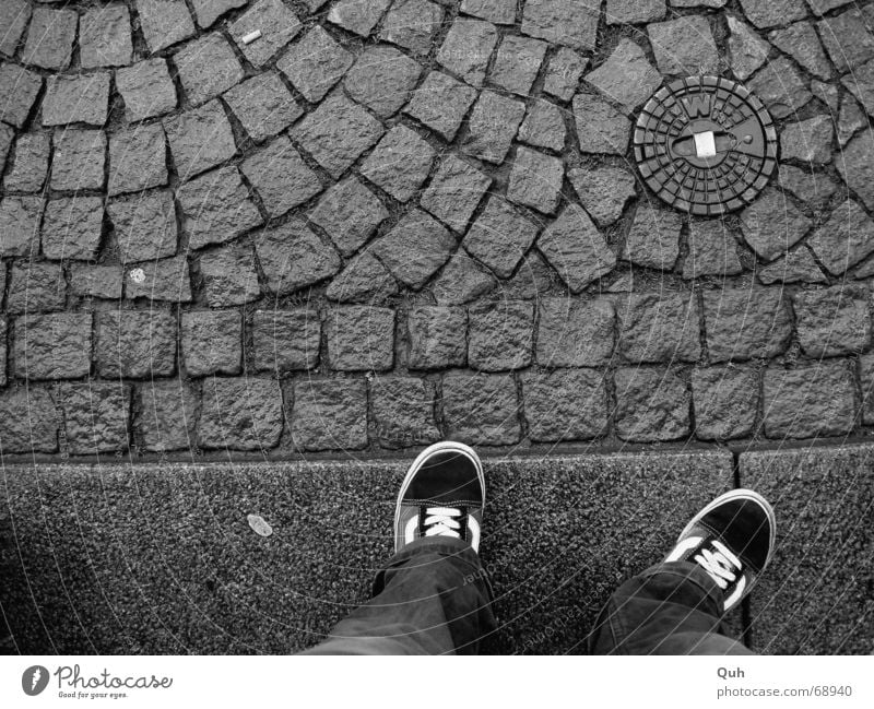 standing waiting wishing Footwear Sidewalk Gully Chewing gum Curbside Pants Boredom Wet Cobblestones ""w"" Legs Feet Wait Rain Paving stone