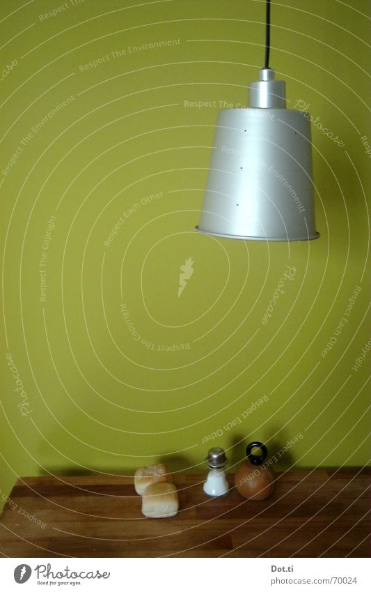 Kitchen table in front of green wall with lamp Colour photo Interior shot Structures and shapes Deserted Copy Space left Copy Space middle Neutral Background