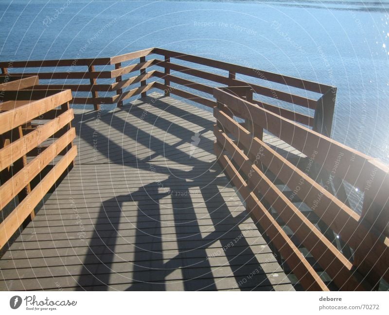 Wood path leading down to the sea on a sunny day. Stripe Lake Ocean Vacation & Travel Relaxation Brown Lanes & trails Walking River Water Blue Architecture