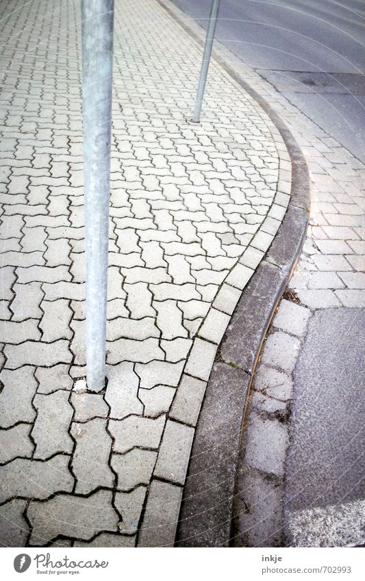 cruise Deserted Transport Traffic infrastructure Street Lanes & trails Sidewalk Curve Curbside Long Winding Line Pave City life Gray Pole Lamp post Colour photo