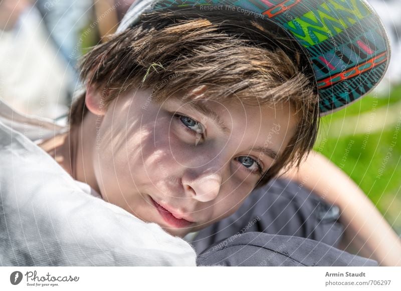 Portrait in bright sunshine Lifestyle Style Human being Masculine Youth (Young adults) Face 1 8 - 13 years Child Infancy Summer Cap Peaked cap Observe Smiling