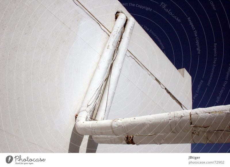 Behind the facade Plaster Wall (building) Electrical equipment House (Residential Structure) Precarious Exterior shot Blue sky Colour Cable Old Pipe