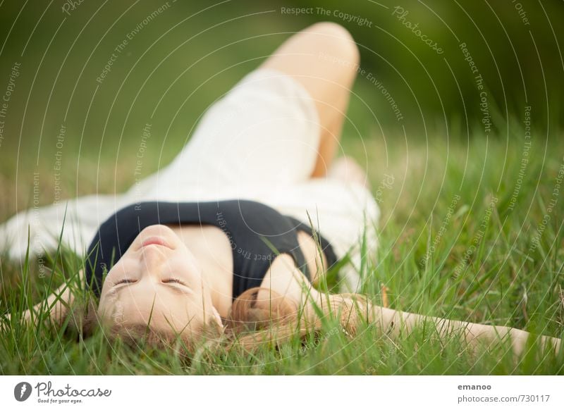 Young woman lying in the grass with her eyes closed Lifestyle Style Joy pretty Harmonious Well-being Contentment Relaxation Calm Fragrance Leisure and hobbies