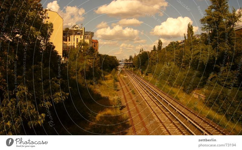 White balance against the sky Summer Clouds Railroad tracks Commuter trains Logistics August sleepers railway embankment Berlin TV Tower metropolitan supply