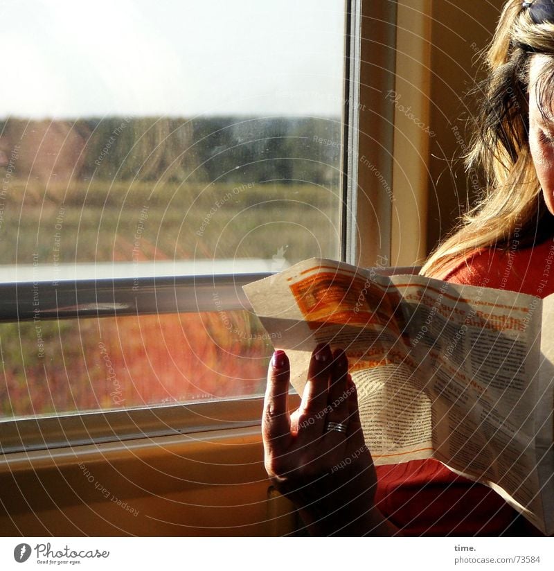 The passing of time Colour photo Subdued colour Interior shot Shadow Reflection Sunlight Sunbeam Reading Woman Adults Newspaper Magazine Railroad