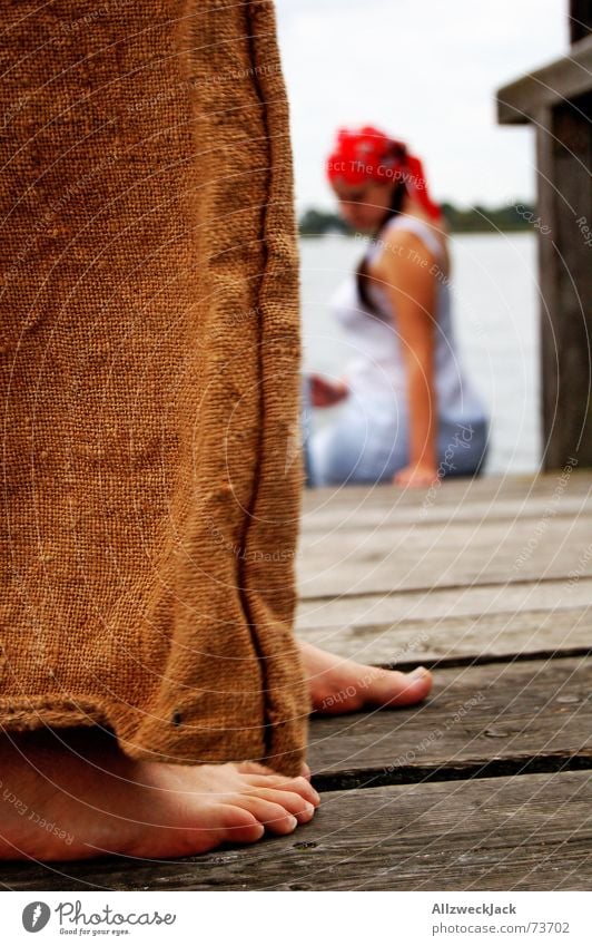 Hans gets close to Grete Footbridge Wood Man Woman Pants Brown Red Headscarf Barefoot Exterior shot Imitate Water Rope Feet creep up hans & grete