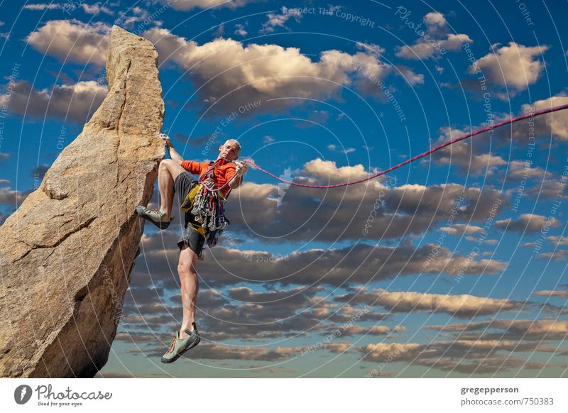 Climber tiptoes on the edge. Adventure Climbing Mountaineering Success Masculine 1 Human being 30 - 45 years Adults Clouds Self-confident Brave Determination