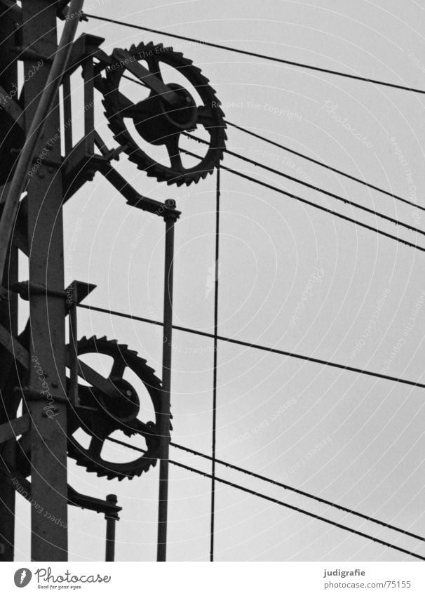 Voltage Railroad system Mechanics Electricity Steel Connectedness Construction Black White Gray Technology Gearwheel Cable Transmission lines Electricity pylon