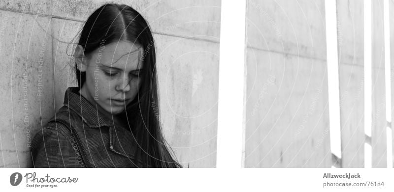 Slipstream Closeup Woman Girl Wall (building) Concrete Black White Exterior shot Black-haired Timidity Wind Loneliness Gloomy Gray Black & white photo