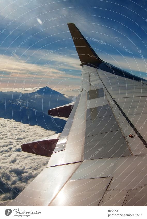 View from a plane over the wing to the island Tenerife and the Teide Vacation & Travel Aviation Mountain Airplane View from the airplane Flying Infinity Blue