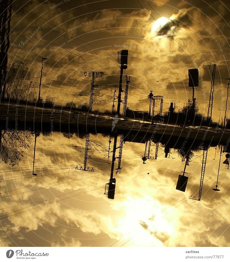 PUTT 2 Puddle Reflection Back-light Overhead line Electricity Railroad tracks Clouds Dramatic Threat Dark Lateness Train station Autumn Electricity pylon