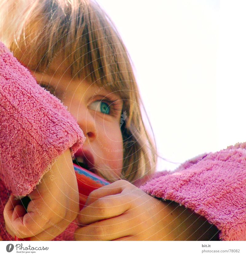 Cute, cute, cute, smiling, little, dreamy, sweet, sweet, blonde girl with pony and sweater in pink, pink observes, curious, interested, cheeky, his surroundings and holds on to the railing from the climbing on the playground.