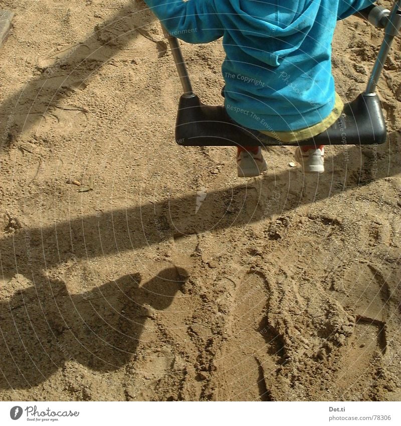 Child on the swing Joy Playing Kindergarten Toddler Infancy 1 Human being 1 - 3 years Sand Park Playground Footprint Movement To hold on To swing Blue