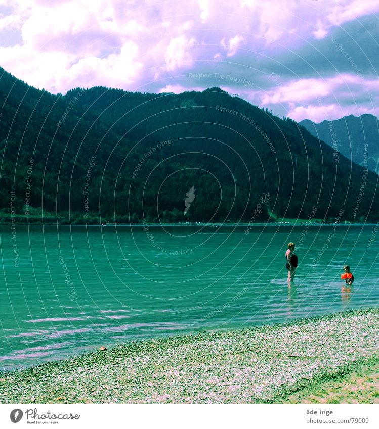 Return to the blue lagoon Lake mountain lake Water bathe Alps Swimsuit Water wings Clouds Beach Gravel Austria Woman Mother Child Vacation & Travel Forest