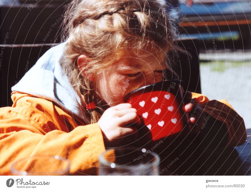 mmm, yummy... Girl Child Blonde Drinking Red Mug Thirsty Fresh Refreshment Portrait photograph Exterior shot Orange Hair and hairstyles