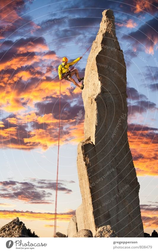 Climber tiptoes on the edge. Adventure Climbing Mountaineering Success Rope Man Adults 1 Human being 30 - 45 years Clouds Peak Helmet Self-confident Brave