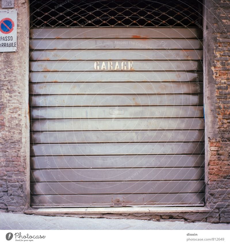 garage Siena Italy Wall (barrier) Wall (building) Garage Garage door Rolling door Brick wall Road sign Clearway Stone Metal Characters Town Analog Medium format