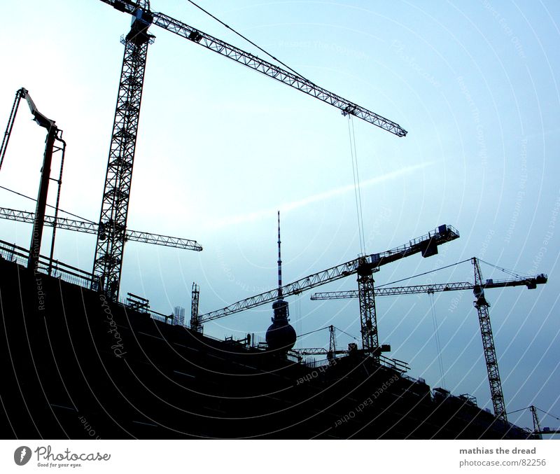 ruffled with cranes Man's work Crane Sky Construction site Steel Concrete Black Dark Work and employment Crane operator Berlin Construction steel Craft (trade)