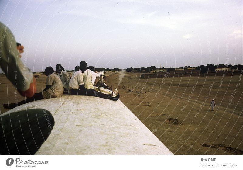 Roofwards Roof of the train Black Full Overload Railroad Driving Man Rear view Ethiopia Poverty Narrow Africa Crowded Mountain range Followers Badlands Beige