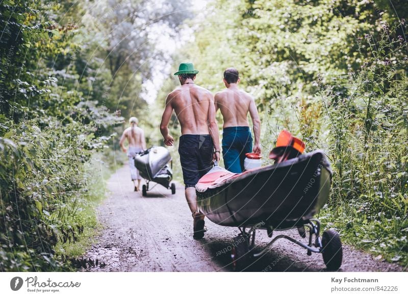 Two men pull a kayak to the water through the forest Lifestyle Leisure and hobbies Vacation & Travel Tourism Trip Freedom Summer Summer vacation Sports Aquatics