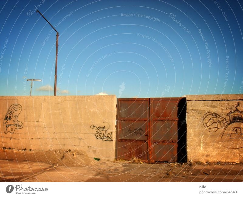 Rusty gate Daub Highway ramp (entrance) Iron Heavy Mysterious Gray Yellow Brown Freight station Munich Derelict Descend Passage Access Portal Boredom Graffiti