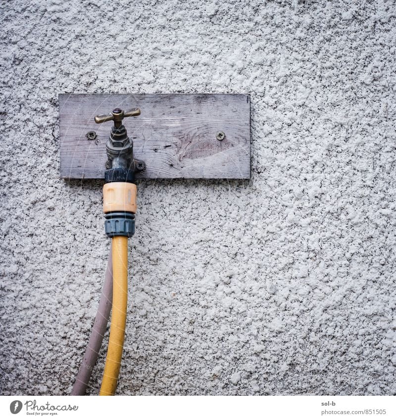 tap Gardening Living or residing Wall (barrier) Wall (building) Old Simple Uniqueness Yellow Tap Hose Connection Water Garden hose Colour photo Exterior shot