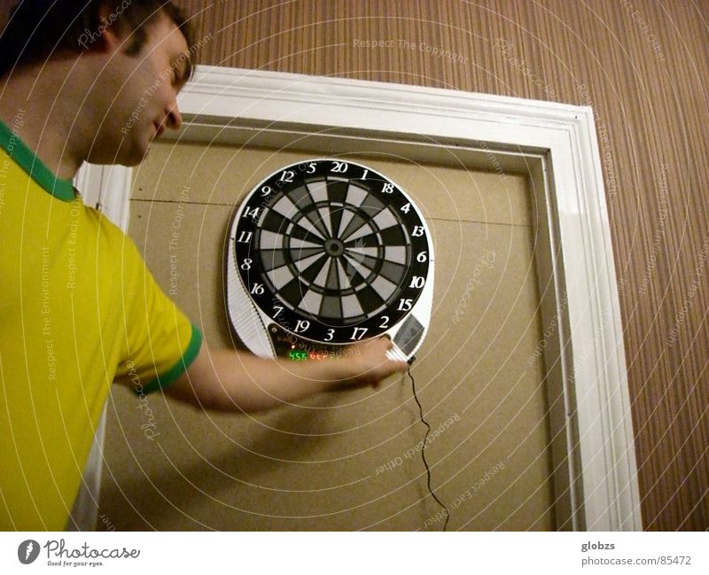 circuit Colour photo Interior shot Artificial light Worm's-eye view Upper body Looking away Joy Playing Darts Sporting event Masculine Young man