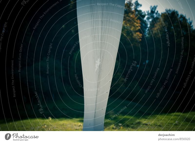 White column standing on a meadow in a valley with dark background, line in the landscape Style Harmonious Calm Trip Hiking Art Work of art Sculpture