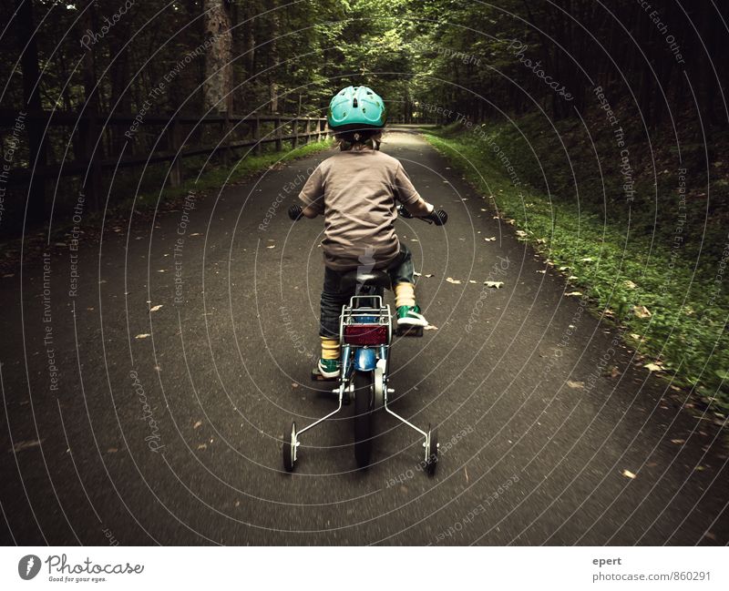 A little man drives in the woods Leisure and hobbies Cycling Child 1 Human being Forest Lanes & trails Bicycle Helmet support wheels Movement Driving Cute Brave