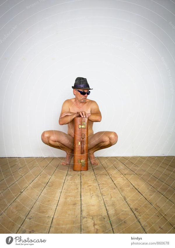 Naked man with sunglasses, hat and an old suitcase in a funny pose Man Adults 1 Human being 45 - 60 years Wooden floor Suitcase Sunglasses Hat Observe Crouch