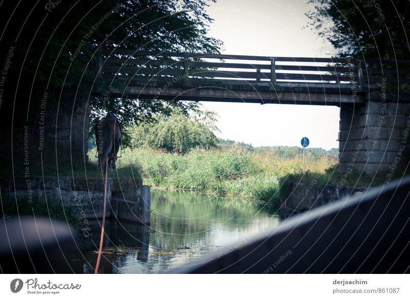 Treidelfahrt on a river. The horse pulls the boat with a long rope. It goes straight under a small bridge. Harmonious Relaxation Calm Watercraft