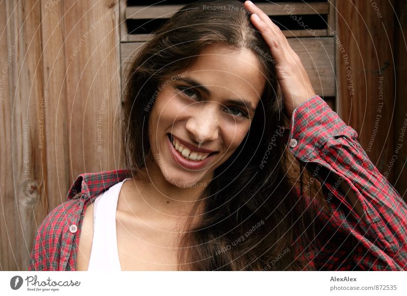 Portrait of a young, beautiful, laughing woman in front of a wooden door Young woman Youth (Young adults) 18 - 30 years Adults Shirt Undershirt Brunette