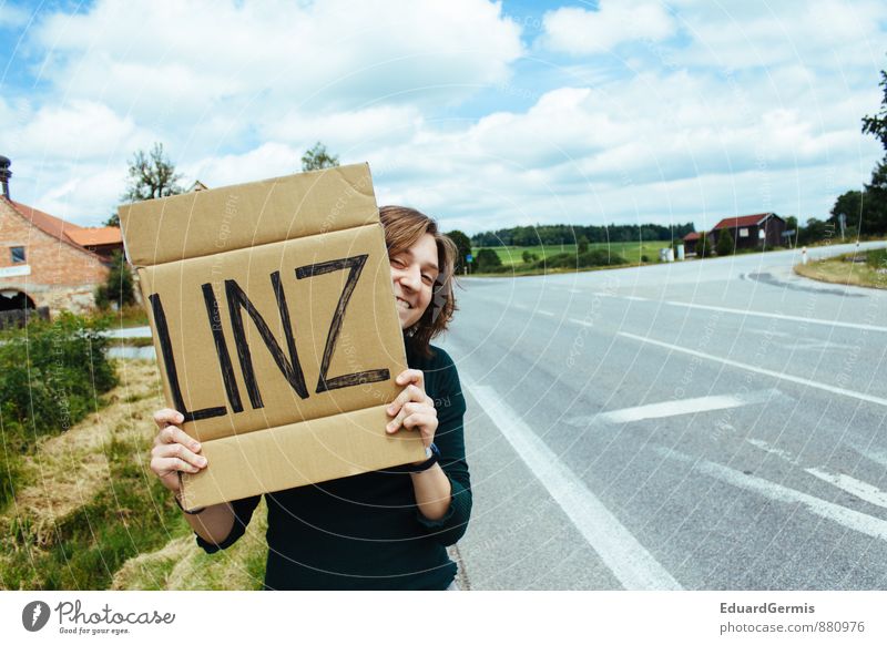 Hitch hiker with shield Lifestyle Vacation & Travel Summer Human being Woman Adults Laughter Authentic Happiness Crazy Blue Gray Green Joy